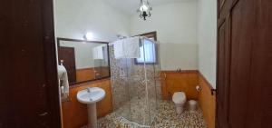 a bathroom with a shower and a toilet and a sink at Suites Vista do Baepi in Ilhabela +25 photos