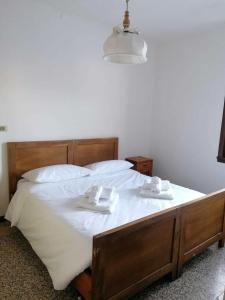 a bed with two white dishes on top of it at GolfHouseApartment in Bocenago
