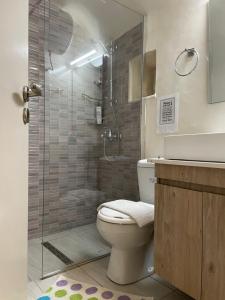 a bathroom with a toilet and a glass shower at The Cocktail House- In the heart of the Island in Chios +12 photos