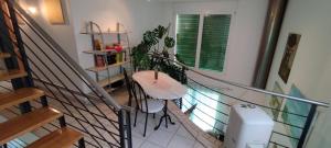 a room with a staircase with a table and plants at Casa Diana Ticino in Cugnasco