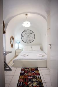 a bedroom with a bed with a clock on the wall at The Cocktail House- In the heart of the Island in Chios