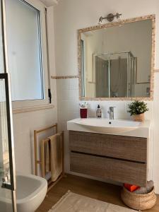 a bathroom with a sink and a mirror at Villa dei Mori in Capitana