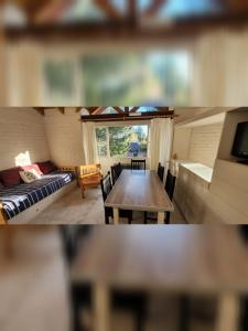 two pictures of a living room with a table and a couch at Rincon del Sur in Esquel