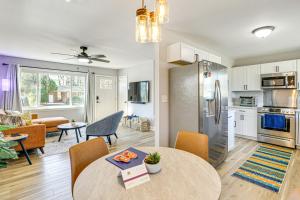 a kitchen and living room with a table and a refrigerator at Conveniently Located North Charleston Home! in Charleston