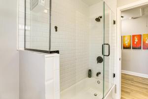 a bathroom with a shower with a glass door at Conveniently Located North Charleston Home! in Charleston +17 photos