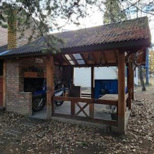 a wooden pavilion with a motorcycle parked in it at Rincon del Sur in Esquel +11 photos