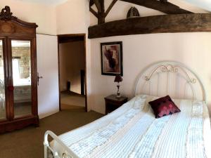 a bedroom with a white bed with a pillow on it at Gîtes Chez Belliveau in Meursac +108 photos