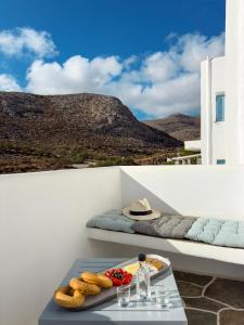 a table with a tray of food on a balcony at ANETON Residences in Karavostasi
