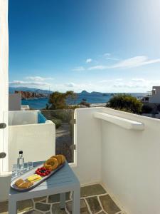 a table with a tray of food on a balcony at ANETON Residences in Karavostasi +21 photos