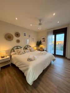 a bedroom with a large white bed and a window at El Legado de Gredos in Candeleda +88 photos