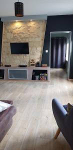 a living room with a wooden floor and a flat screen tv at 8 seater house near Chinon in Beaumont-en-Véron +1 photo