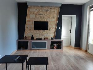 a living room with a flat screen tv on a wall at 8 seater house near Chinon in Beaumont-en-Véron