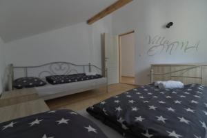 a bedroom with two beds with a american flag bedspread at Villa Emma in Zovik