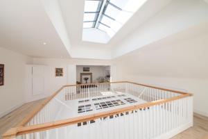 a white staircase with a skylight in a house at Prince Hill House in Devizes