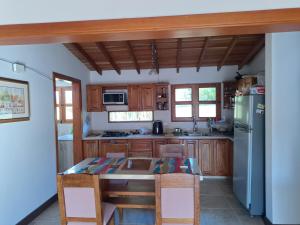 a kitchen with a table and a refrigerator at Habitación en Casa San Miguel, Vereda El Plan, Santa Elena in Medellín
