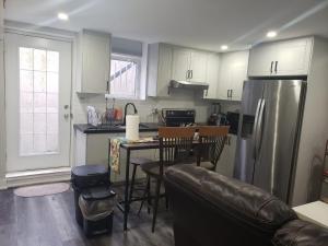 a kitchen with a refrigerator and a table with chairs at Velohome - 3-Bed, 2-Bath Home in Milton