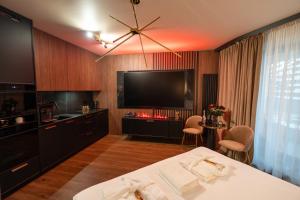 a hotel room with a bed and a flat screen tv at Apartament z jacuzzi, Wiślane Tarasy in Krakow