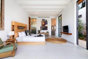 a bedroom with a king sized bed and a television at Amazing Luxury Villa in Ban Thung