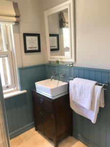 a bathroom with a sink and a mirror at The Little House in Ballynacarrow +8 photos
