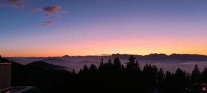 a view of the sun setting over the mountains at Chamrousse - Résidence Le Vernon in Chamrousse