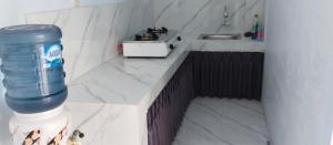 a model of a kitchen with a water bottle on a counter at Al Yama Homestay Syariah in Brassan +63 photos