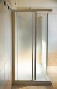 a glass shower door in a bathroom at Laguna Venice Apartment in Dogaletto +13 photos
