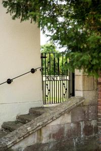 a black gate on the side of a building at Prince Hill House in Devizes