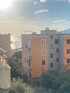 a view of an apartment building and the ocean at Marico Apartment in Salerno