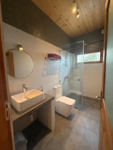 a bathroom with a sink and a toilet and a shower at Weligama Ocean Breeze in Weligama