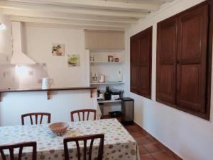 a kitchen with a table and chairs in a room at Gîte Lagrave in Arette +15 photos