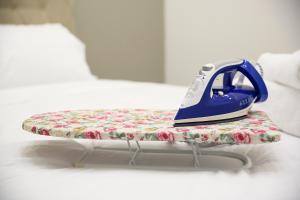 a blue iron sitting on top of a pillow at #1 Ioanna Apartments in Thessaloniki