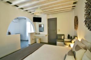 a bedroom with a bed and a living room at Myrto Bungalows in Artemonas