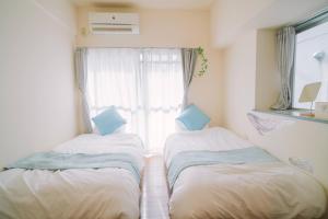 Ένα ή περισσότερα κρεβάτια σε δωμάτιο στο MinamiFukuokaHouse