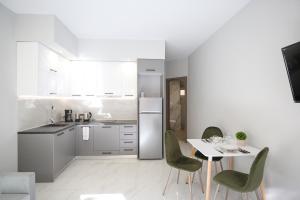 a kitchen with a table and chairs and a refrigerator at #2 Ioanna Apartments in Thessaloniki