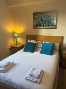 a bedroom with a bed with towels on it at AB11 Apartments - Portland Street in Aberdeen