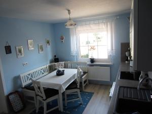 a kitchen with a table and chairs and a window at Ferienwohnung Bienwald mit Pool für 4 - 6 Personen mit 3 Schlafzimmern in Gröbitz