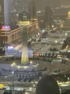 a view of the space needle at night at 41-40 этаж Отель Bon Dian in Astana +11 photos