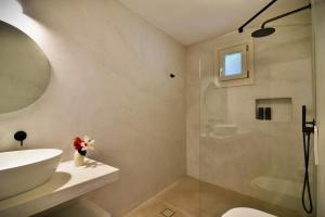 a bathroom with a sink and a toilet and a shower at Myrto Bungalows in Artemonas +57 photos