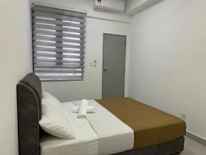 a bedroom with a bed with two pillows and a window at 168 KL Selayang Cottage Homestay in Batu Caves +35 photos