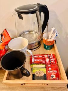 a table with a coffee pot and a cup of coffee at Akasia Pyramids View in Cairo +39 photos