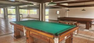 a room with a pool table and a piano at Flat Guarajuba Summer House - Bahia in Guarajuba
