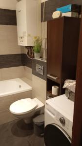 a small bathroom with a toilet and a sink at Mieszkanie niedaleko centrum in Gdańsk