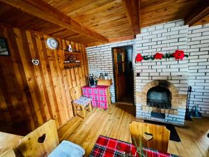 a living room with a brick fireplace in a house at Chata Juliana in Malý Lipník