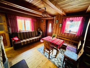 a living room with a table and a couch at Chata Juliana in Malý Lipník