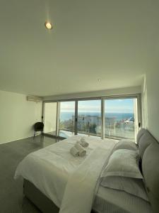 a bedroom with a large bed with a large window at Casa Klei in Ulcinj +11 photos