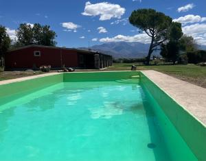 a pool of blue water in front of a house at Posada La Escondida in San Carlos