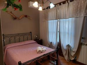 a bedroom with a bed with two towels on it at Agriturismo Dinoabbo Ulivi in Lucinasco