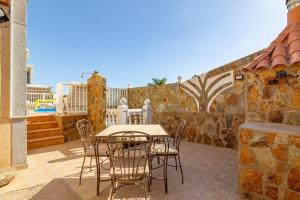 a table and chairs sitting on a patio at Meloneras Hills Private Villa in Meloneras