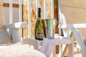 a bottle of wine is sitting on a chair at Meloneras Hills Private Villa in Meloneras