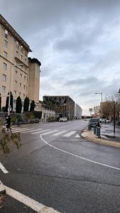 an empty street in a city with a building at Port Royal in Aix-en-Provence